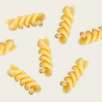 Yellow spiral pasta on a light beige background