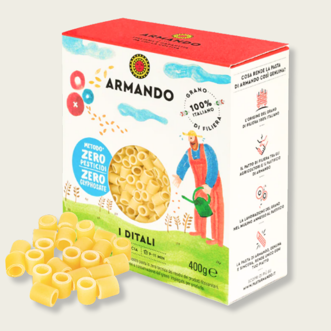 Box of Armando pasta with a man watering plants illustration and pasta pieces on a light gray background