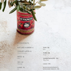Red can labeled 'Kyknos' with olive branches on a textured surface