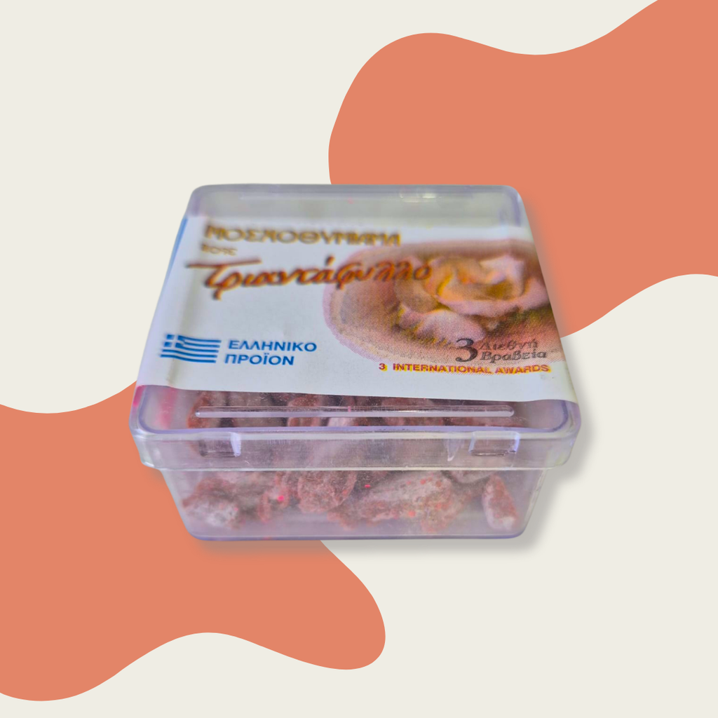 Container of Troodos honey with Greek logo on a colorful background
