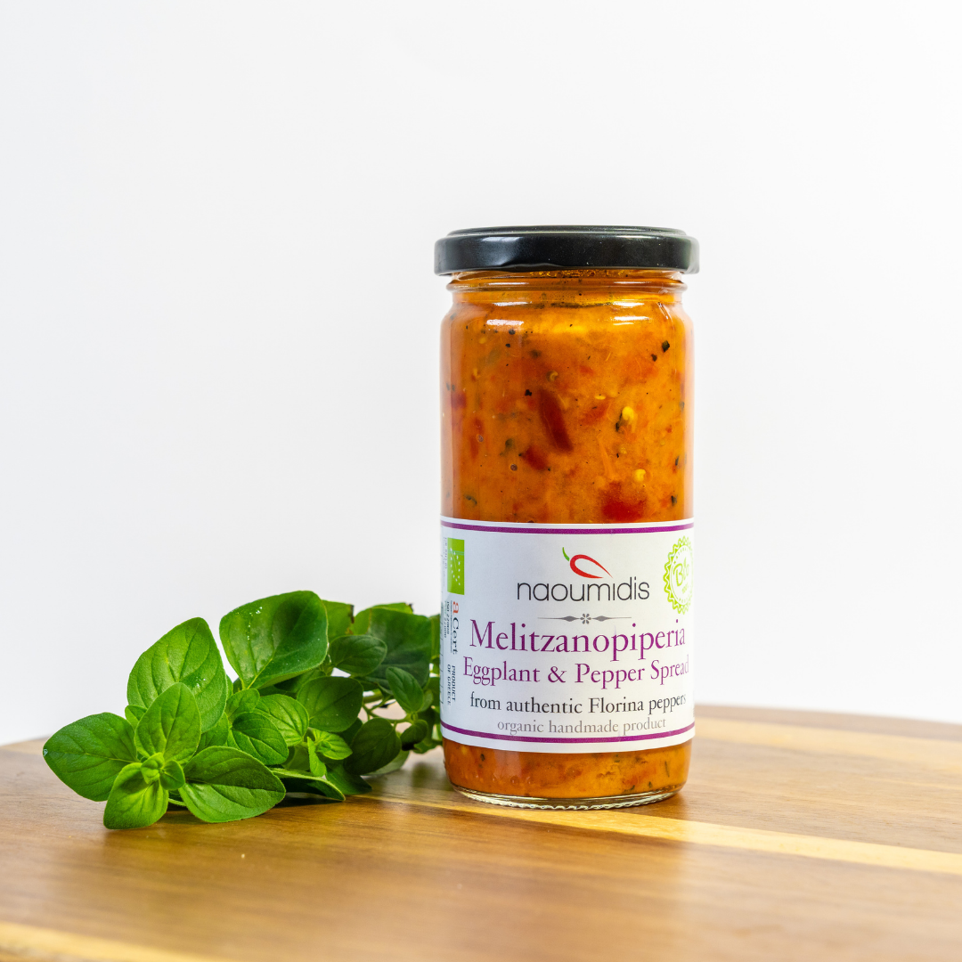 Jar of Naoumidis Meltzanopiperita on a wooden surface with a white background