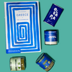Collection of Greek-themed products including a cookbook and various containers on a teal background