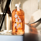 Bottle of Olé Pia on a metallic surface with a blurred background