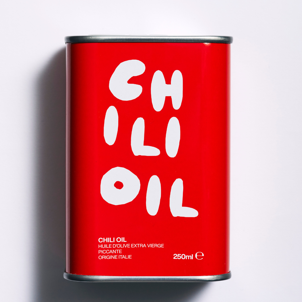 Red can of chili oil with white text on a light gray background