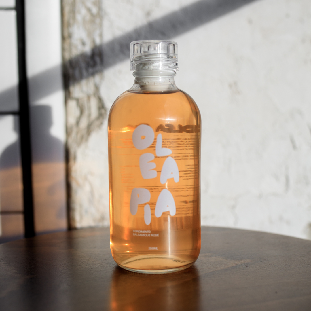 Bottle of OLA PA juice on a wooden surface with a light background