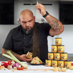 Man in a kitchen with pasta and 'Lucky Pasta' cans