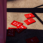 Red packets of chili oil on a concrete surface