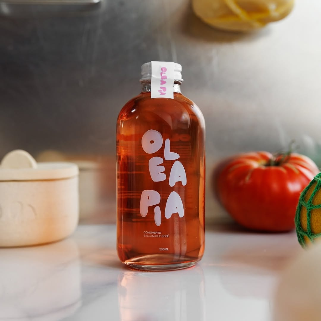 Bottle of Olea Pia on a kitchen counter with pumpkins in the background